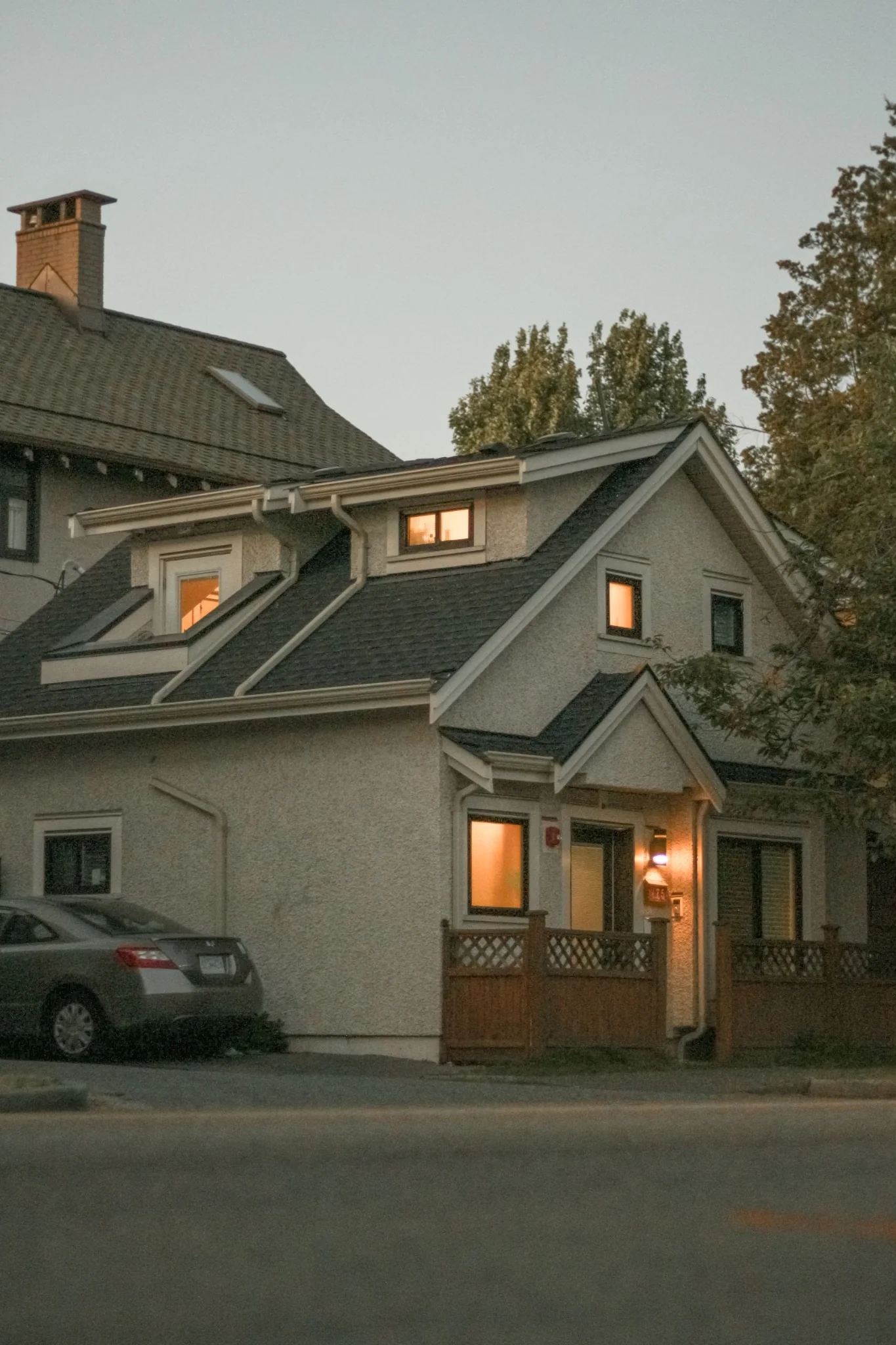 Home at dusk with warm lights in the windows