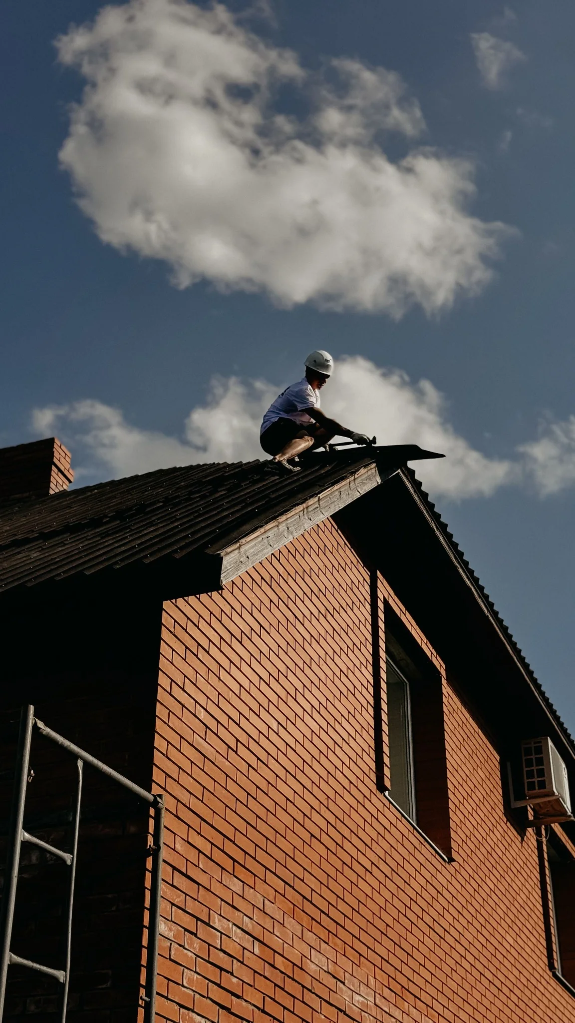 Roof inspection in progress under a blue sky
